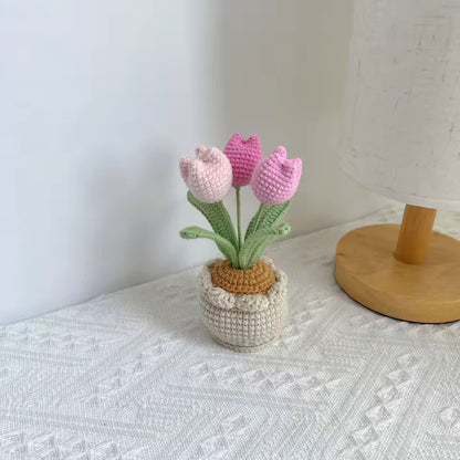 Hand-crocheted red roses in a knit pouch