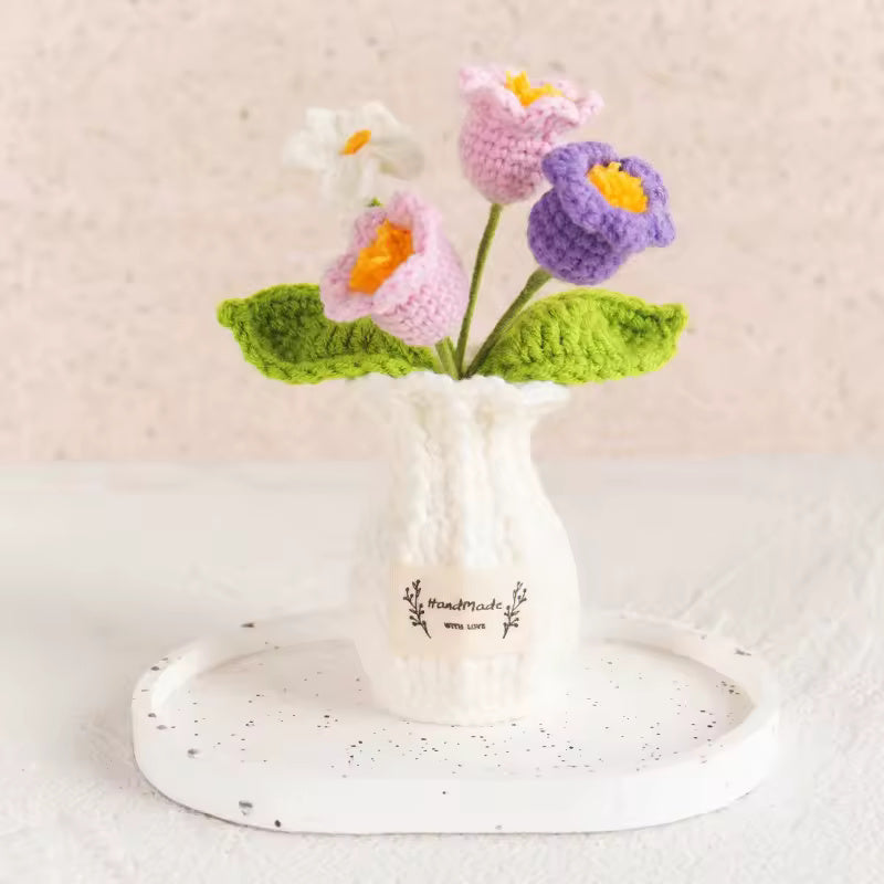 Hand-crocheted mixed primrose flowers in a mustard vase
